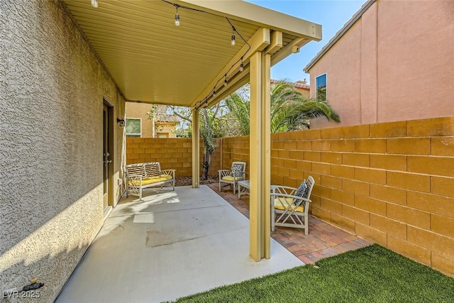 view of patio featuring fence