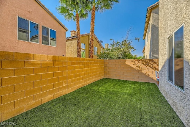view of yard with a fenced backyard
