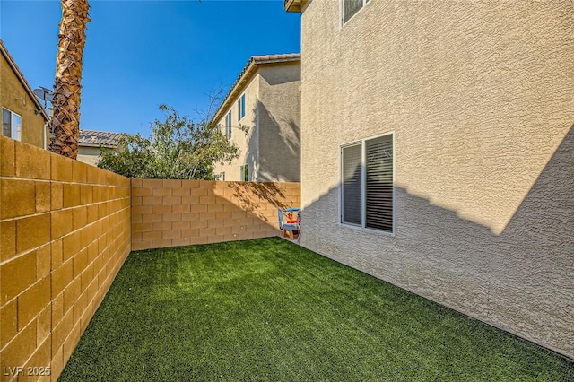view of yard with a fenced backyard