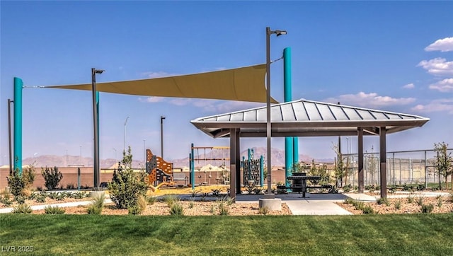 view of property's community with a yard and fence