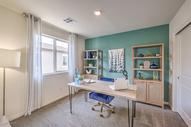 carpeted office with baseboards and visible vents