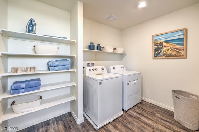 clothes washing area with laundry area, visible vents, washing machine and clothes dryer, dark wood-style floors, and baseboards