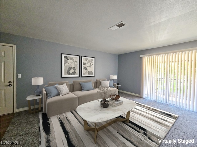 carpeted living room with a textured ceiling, visible vents, and baseboards