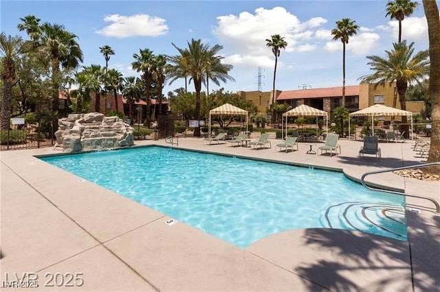 pool with a gazebo, a patio area, and fence