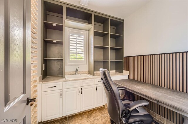 office area featuring built in shelves and a sink