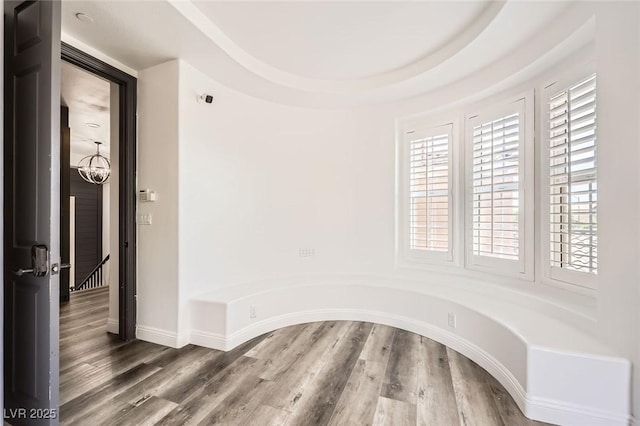 interior space with baseboards and wood finished floors