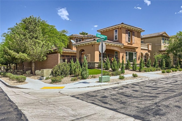 mediterranean / spanish-style house featuring stucco siding and a tile roof