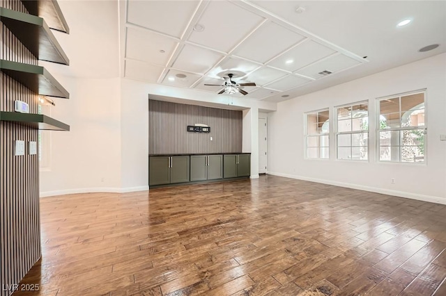 unfurnished living room with coffered ceiling, baseboards, a ceiling fan, and wood-type flooring