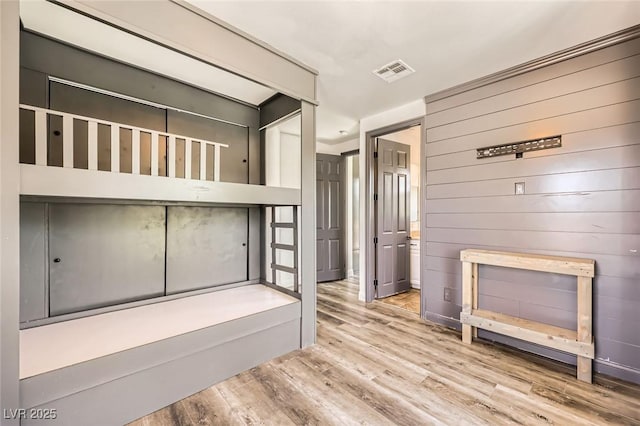 interior space with visible vents and wood finished floors