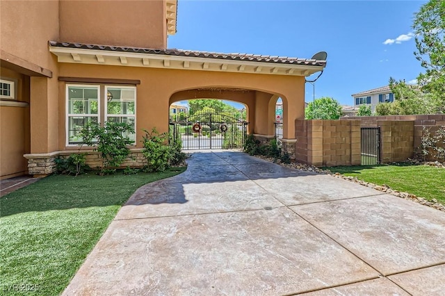 exterior space with a yard, stucco siding, a gate, and fence