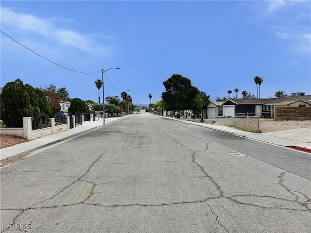 1004 Stone River Dr, North Las Vegas, NV 89030 - view of asphalt street featuring sidewalks, curbs, and street lights
