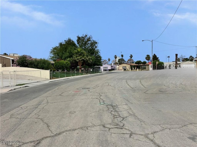 1004 Stone River Dr, North Las Vegas, NV 89030 - view of asphalt road with sidewalks, street lighting, and curbs