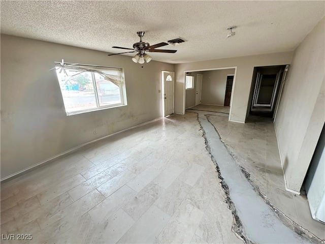 1004 Stone River Dr, North Las Vegas, NV 89030 - spare room featuring a textured ceiling, a ceiling fan, and baseboards