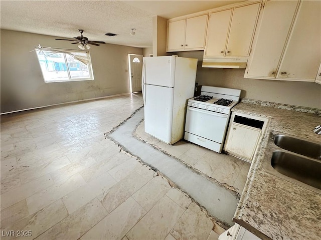 1004 Stone River Dr, North Las Vegas, NV 89030 - kitchen featuring white appliances, under cabinet range hood, a ceiling fan, a sink, and light countertops