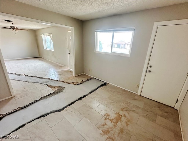 1004 Stone River Dr, North Las Vegas, NV 89030 - entryway with ceiling fan, a textured ceiling, and baseboards
