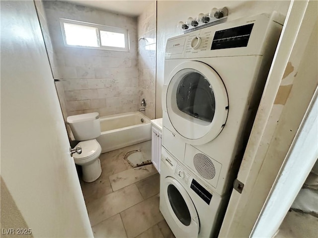 1004 Stone River Dr, North Las Vegas, NV 89030 - clothes washing area with estacked washer and dryer and light tile patterned flooring