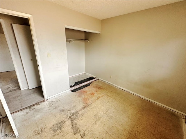 1004 Stone River Dr, North Las Vegas, NV 89030 - unfurnished bedroom featuring a closet, a textured ceiling, and baseboards