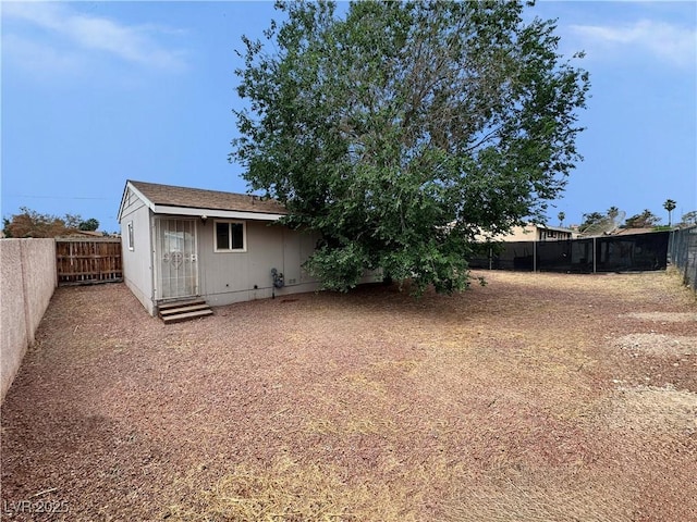 1004 Stone River Dr, North Las Vegas, NV 89030 - rear view of house with a fenced backyard and entry steps
