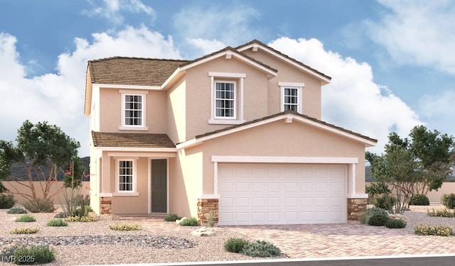 traditional home featuring stucco siding, stone siding, and driveway