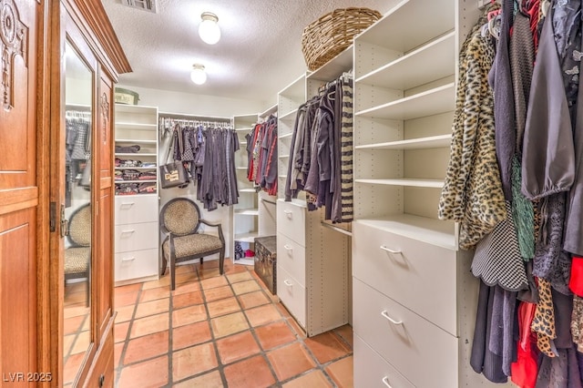 spacious closet featuring visible vents