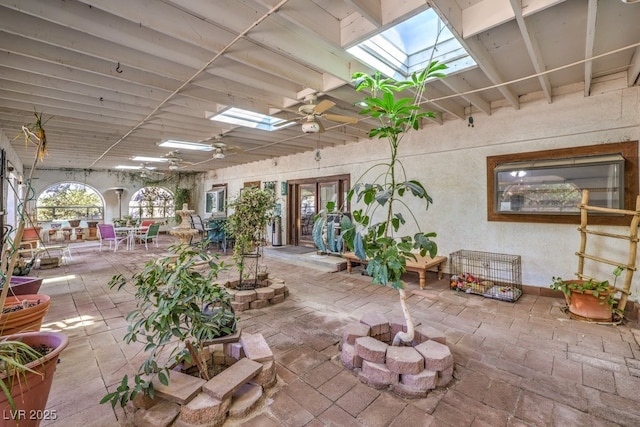 misc room with ceiling fan and a skylight