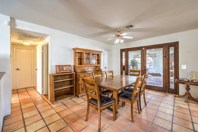 dining area with a ceiling fan, french doors, visible vents, and light tile patterned floors