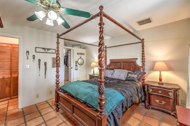 bedroom with a ceiling fan, visible vents, and tile patterned floors
