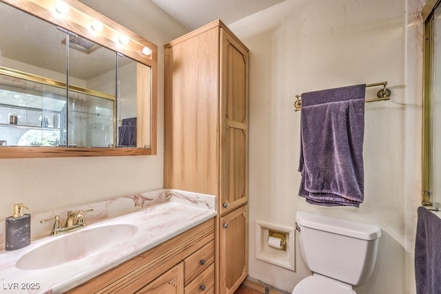 full bathroom featuring toilet, a shower with door, and vanity