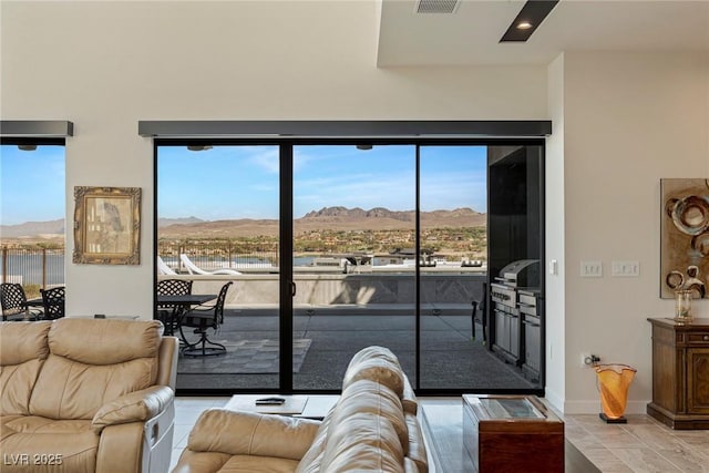living area featuring baseboards, visible vents, and a mountain view