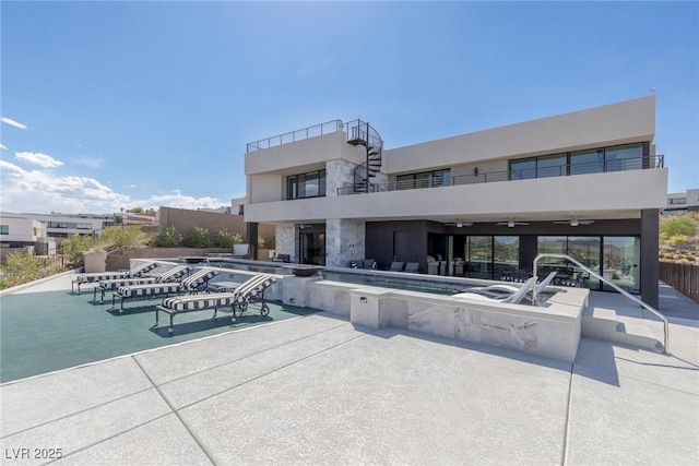 community pool featuring a ceiling fan, a patio area, and a jacuzzi