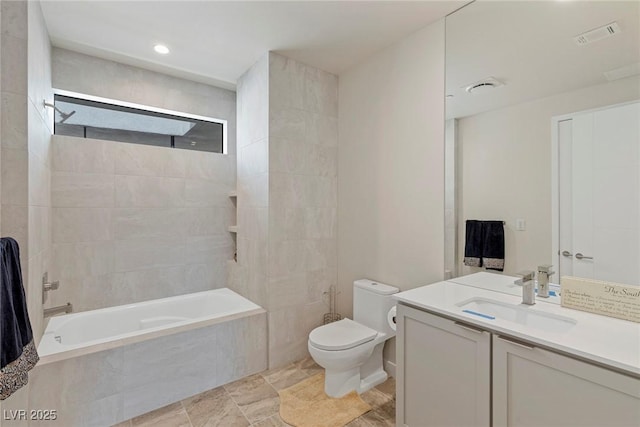 bathroom with toilet, visible vents, tiled shower / bath combo, and vanity