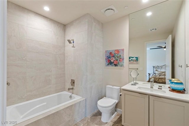 full bath with toilet, tiled shower / bath, visible vents, vanity, and recessed lighting