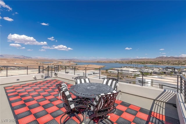 view of patio featuring a water and mountain view
