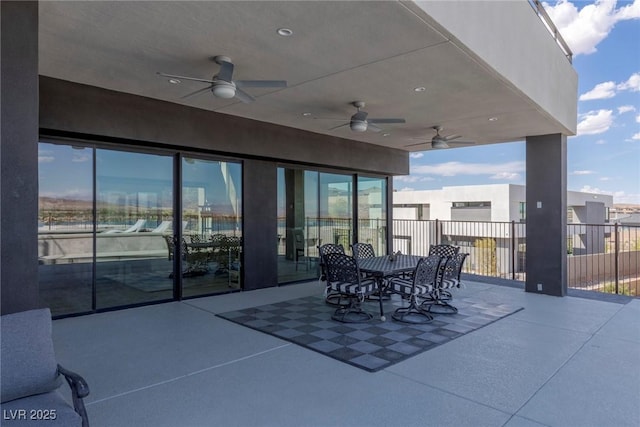 view of patio / terrace with ceiling fan, fence, and outdoor dining space