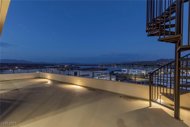 view of patio / terrace featuring a water view and stairway