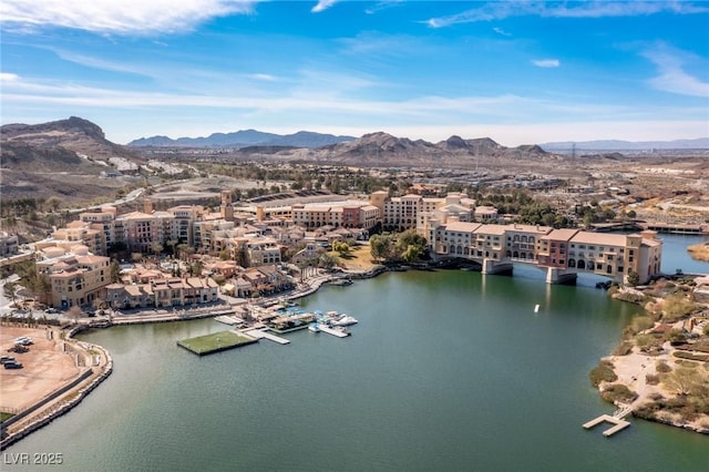 drone / aerial view with a water and mountain view