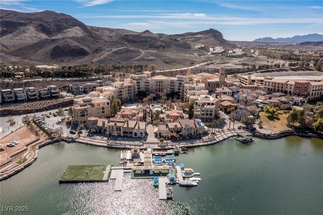 drone / aerial view with a water and mountain view