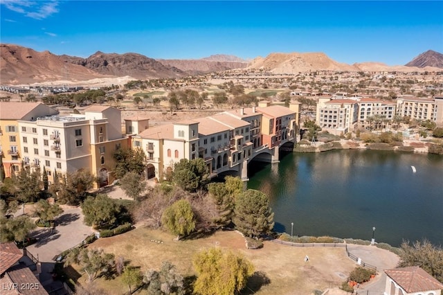 birds eye view of property with a water and mountain view