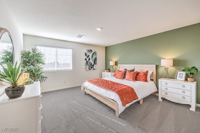 carpeted bedroom featuring baseboards and visible vents