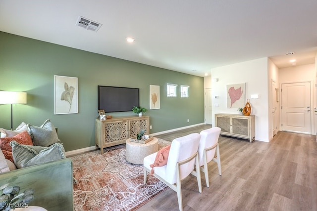 living room with baseboards, recessed lighting, visible vents, and wood finished floors