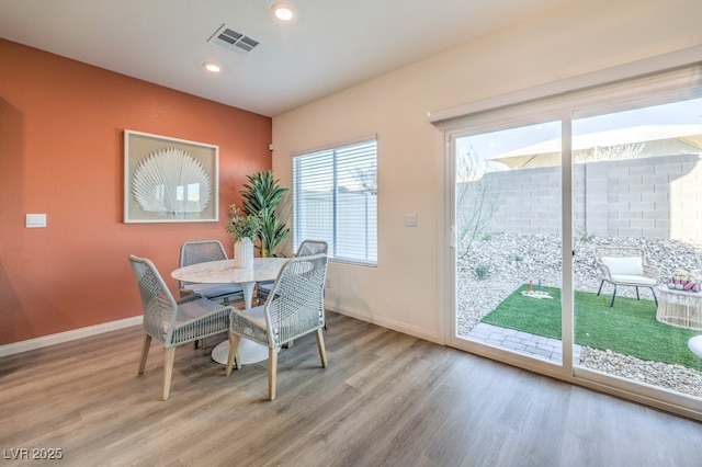 dining room with light wood-type flooring, recessed lighting, baseboards, and visible vents