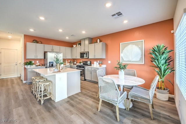 kitchen with light wood-style flooring, visible vents, light countertops, appliances with stainless steel finishes, and recessed lighting