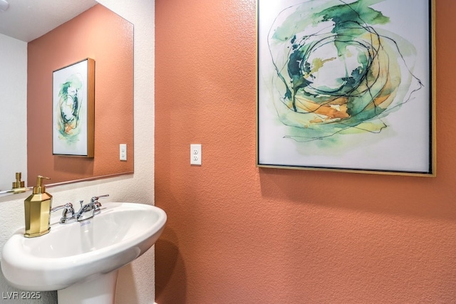 bathroom with a sink and a textured wall