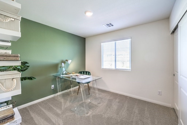 carpeted office space with baseboards and visible vents