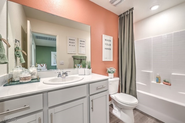 full bath with toilet, wood finished floors, shower / bath combo, visible vents, and vanity