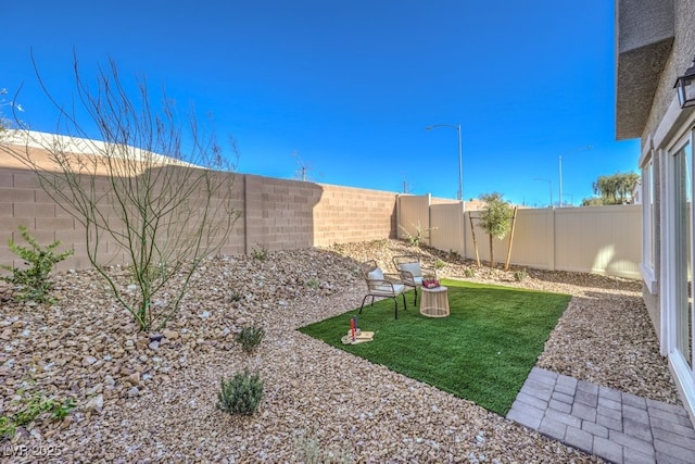 view of yard with a fenced backyard