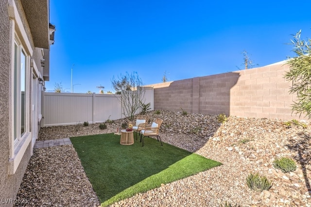 view of yard with a fenced backyard