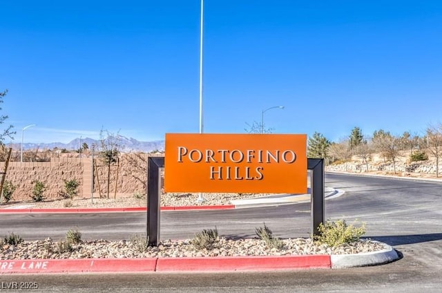 community sign with a mountain view