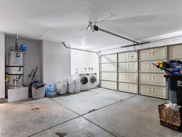 garage featuring strapped water heater, washing machine and clothes dryer, and a garage door opener