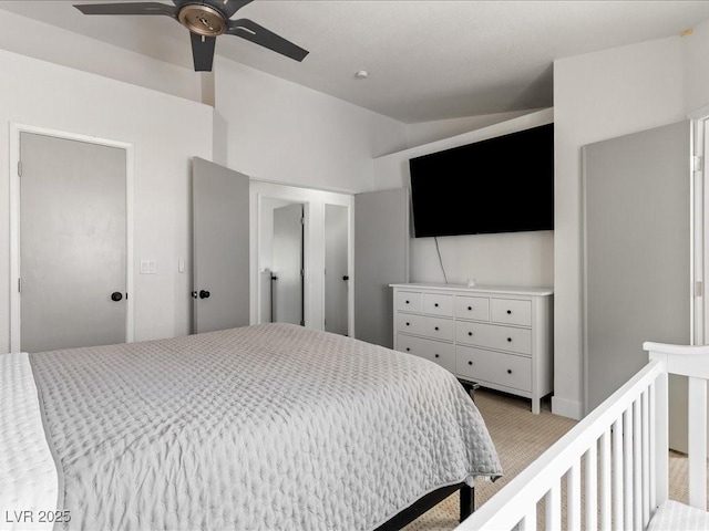 bedroom featuring light carpet, vaulted ceiling, and ceiling fan